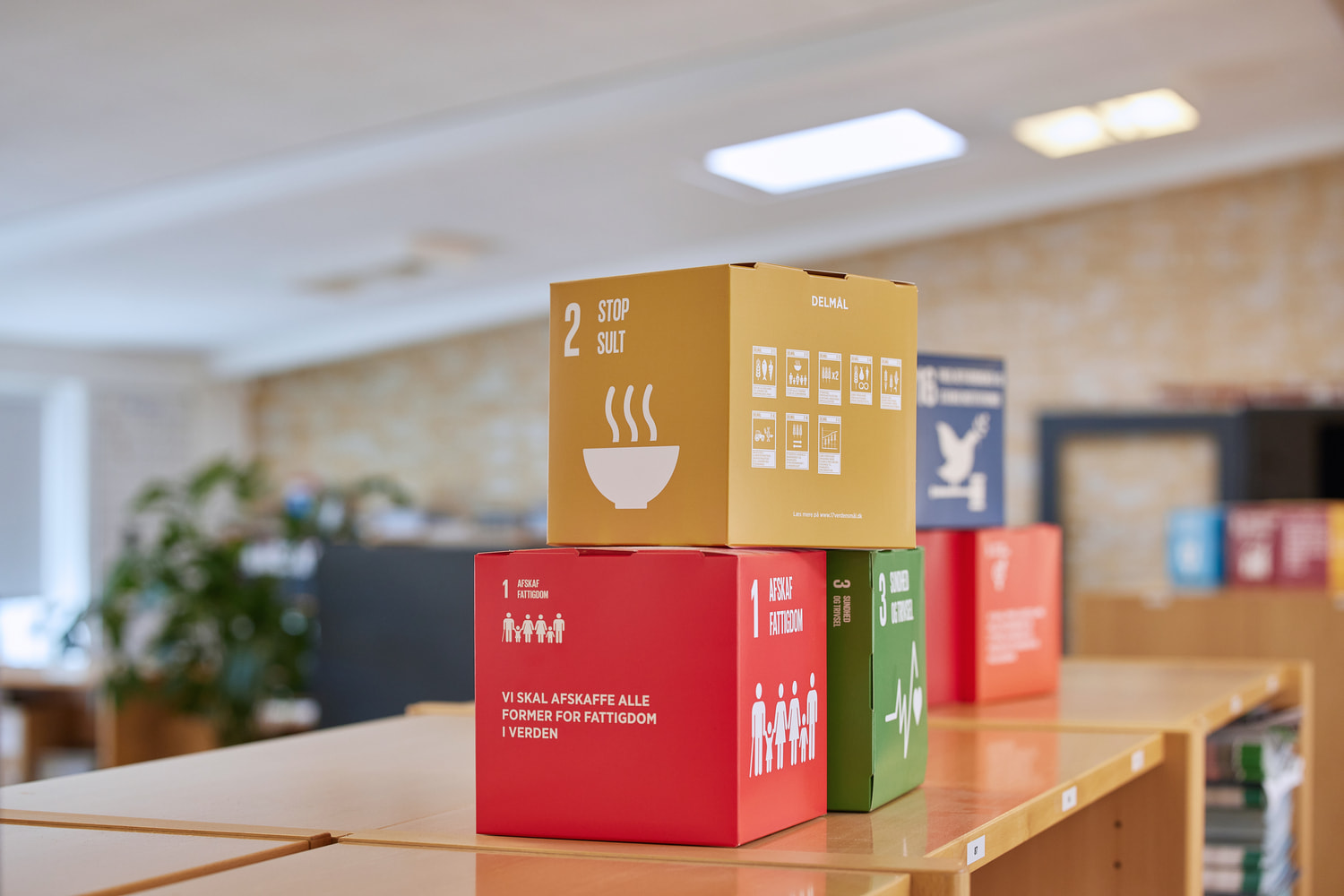 Boxes with global goals on them lay on table at JS Denmark